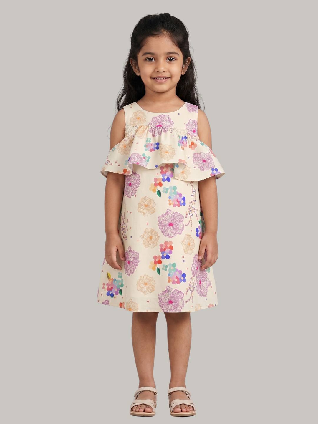 Cold-shoulder floral dress with ruffle overlay detail.