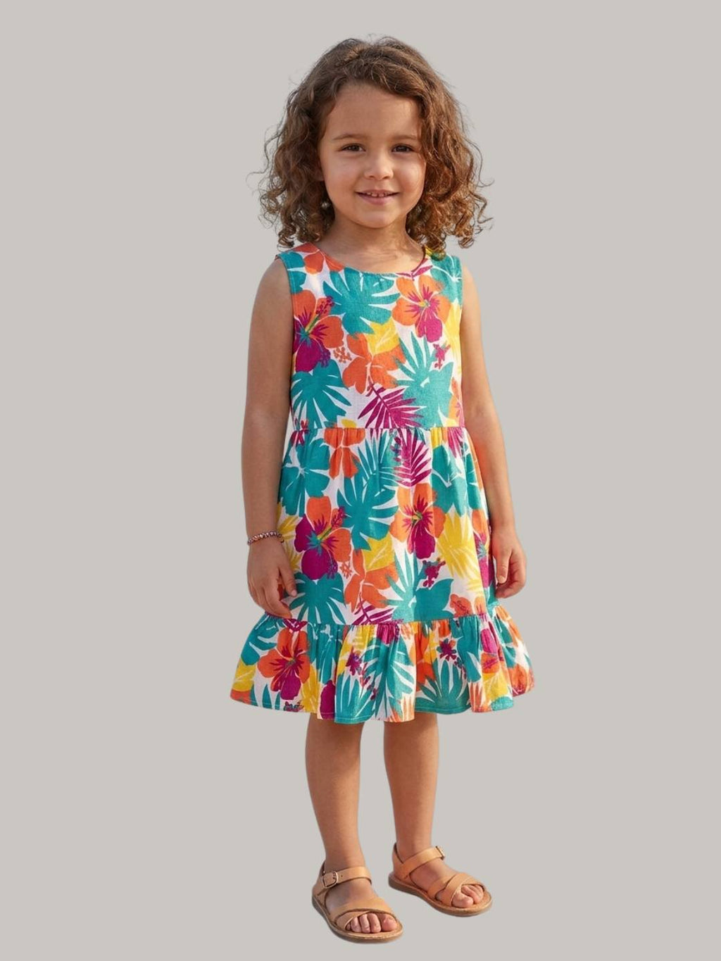 Bright tropical floral dress with sleeveless design and ruffle hem