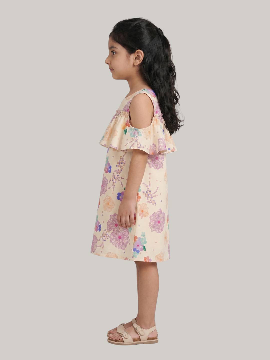 Cold-shoulder floral dress with ruffle overlay detail.