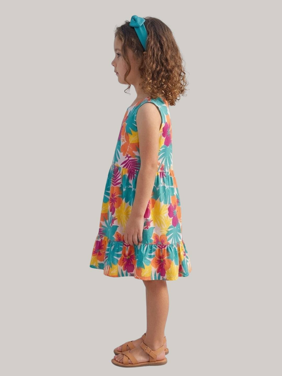 Bright tropical floral dress with sleeveless design and ruffle hem