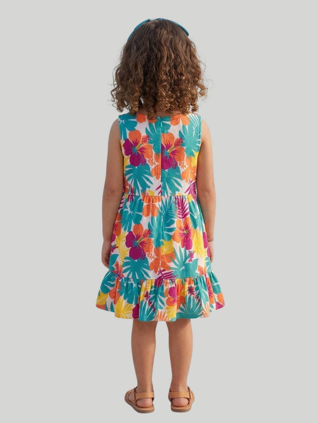 Bright tropical floral dress with sleeveless design and ruffle hem