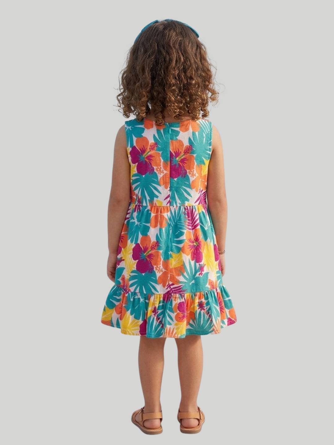 Bright tropical floral dress with sleeveless design and ruffle hem