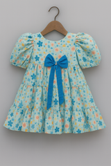 Girls Tiered Floral Cotton Dress with Puffed Sleeves & Statement Bow – Summer Party Wear | Kevora Kidswear